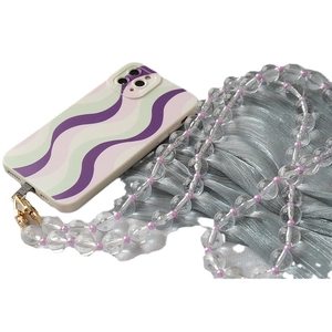 Transparent acrylic bead chain strap with wavy green and purple phone case on fabric