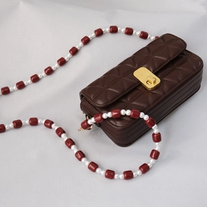 Quilted brown leather bag with candy-colored acrylic beads and pearl chain shoulder strap