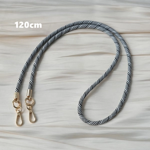 Detail of 120cm black and white woven phone strap with high-gloss gold metal hooks