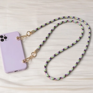 Detail of lavender silicone phone case with colorful woven crossbody strap and gold clasps