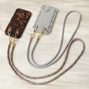 Detail of crossbody braided phone lanyards with leopard and silver wave phone cases