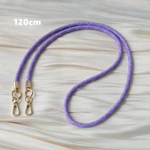 Close-up of 120cm purple braided mobile phone strap with gold metal hooks on silk cloth