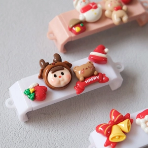 Detailed macro view of resin 3D Christmas charms featuring reindeer boys and gingerbread bears