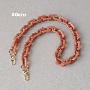 Close-up of 80cm pink acrylic chain strap with gold metal rings for shoulder bags