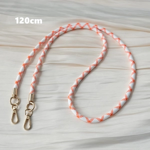 Detail of 120cm orange and white woven shoulder strap with polished gold metal hooks