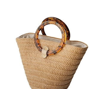 Straw handbag with round amber resin handles and woven texture for summer