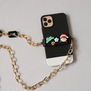 Detail of Christmas phone case with 3D festive elements and a long gold chain strap