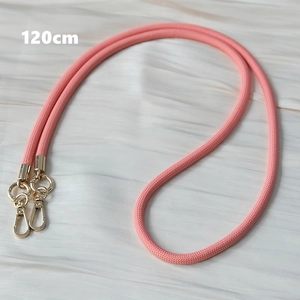 Detail of pink woven crossbody phone strap with golden metal swivel hooks and 120cm length