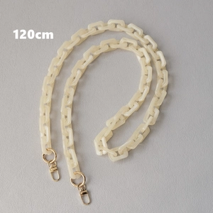 Detailed view of 120cm cream acrylic bag chain with golden metal lobster clasps