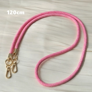 Detailed macro view of a 120cm pink and white woven phone strap with gold metal swivel hooks