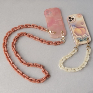 Detail of pink and cream phone cases with chunky acrylic chains and peach rabbit print