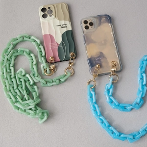 Detail of acrylic resin chain straps and smile-printed phone cases with metal hooks