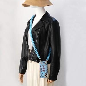 Sky blue acrylic chunky chain strap for phone case styled on model with black leather jacket
