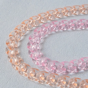Close-up of thick amber and pink acrylic resin fishbone chain links for bags and accessories
