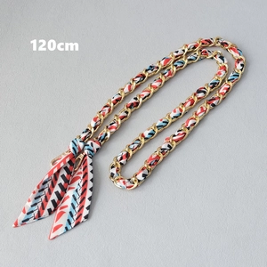 Detail of 120cm gold chain strap interwoven with colorful geometric silk scarf for handbags