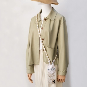 Chic phone case with gold metal chain interwoven with a silk scarf, shown as a crossbody