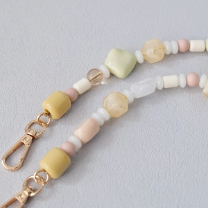 Close-up of acrylic beaded chain with gold lobster clasps for phones and bags