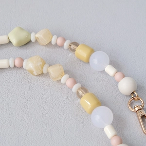 Macro detail of macaron acrylic beads with high-quality gold metal lobster clasp