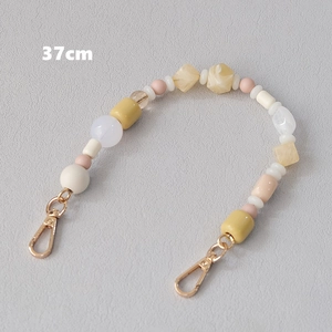 Detailed view of 37cm acrylic bead chain with golden metal clasps in pastel colors