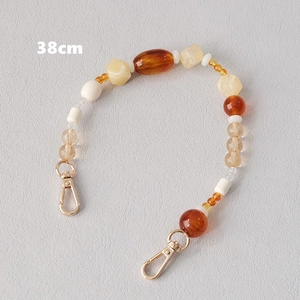 Detail of 38cm acrylic bead chain with amber resin beads and gold lobster clasps