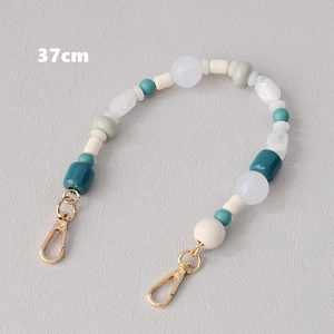 Close-up of a 37cm acrylic beaded strap with blue and white beads and gold lobster clasps