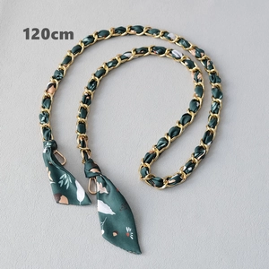 Detail view of 120cm gold chain strap interwoven with green floral silk ribbon and clasps