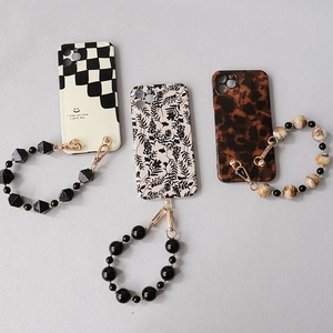 Acrylic bead phone strap with checkerboard and marble textures in a stylish three-piece set