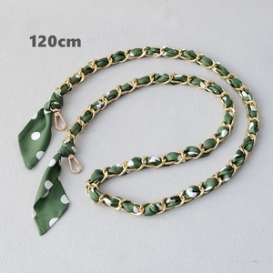 Detail view of 120cm gold chain interwoven with dark green polka dot silk ribbon strap