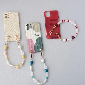 Three acrylic beaded phone strap sets with colorful silicone cases and charms