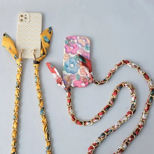 Fashionable phone case with silk scarf chain strap in vibrant wave and floral patterns