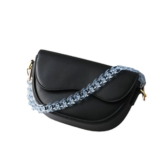 Black matte leather saddle bag with light blue acrylic chain strap and metal buckles