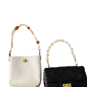 Chic acrylic beaded straps on white bucket bag and black quilted leather handbag