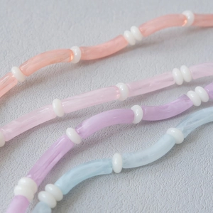 Detailed macro view of colorful candy-colored acrylic tube bead straps with a creamy texture