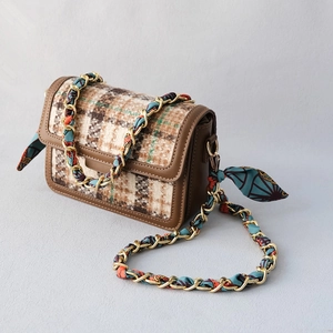 Detailed view of vintage plaid crossbody bag with silk scarf wrapped chain strap