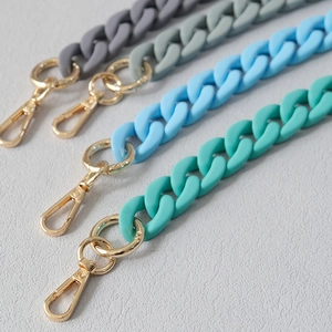 Close-up of matte Morandi color acrylic chain straps with golden lobster clasps