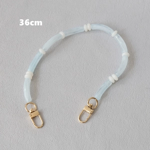 Close-up of a 36cm blue acrylic marble bead chain with gold metal lobster clasps