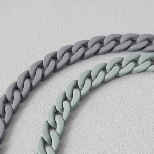 Close-up of matte resin curb chain links in dark grey and light turquoise colors
