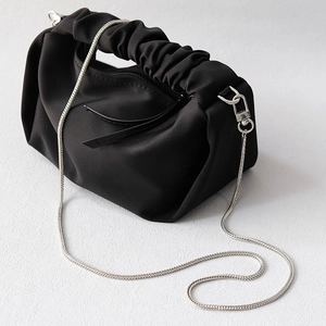 Fashionable black pleated cloud bag with elegant silver chain strap and top handle