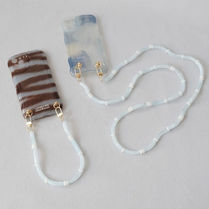 Detail of wave-edged phone cases with colorful acrylic beaded long lanyards and hooks