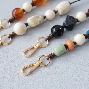Close-up of colorful acrylic bead strap with jade-style resin beads and golden metal clasp