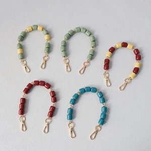 Colorful resin bead handbag chains with golden lobster clasps in five different vibrant colors
