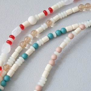Detail of colorful acrylic beaded straps featuring mixed shapes and vibrant colors