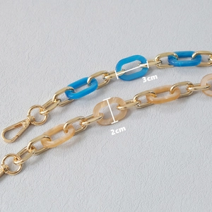 Fashionable acrylic and metal bag strap chain with blue resin links and gold lobster clasp