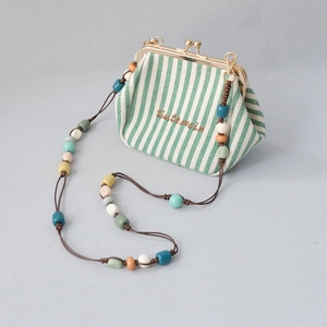 Striped canvas frame bag with colorful acrylic bead chain and golden metal clasp