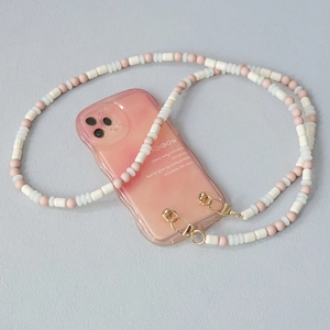 Detail view of pink acrylic bead strap with gold clasp and gradient rainbow phone case