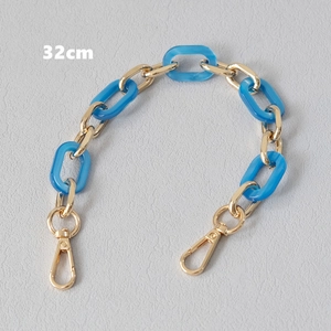Detail view of 32cm blue acrylic and gold metal link chain strap with lobster clasps