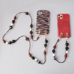 Acrylic beaded crossbody phone strap with black and red resin pearls and gold metal hooks