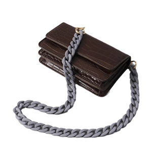 Brown faux crocodile leather handbag with matte grey chunky chain and accordion layers