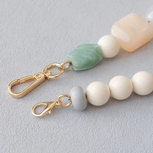 Detail view of colorful acrylic resin beaded chain with dual gold lobster clasps