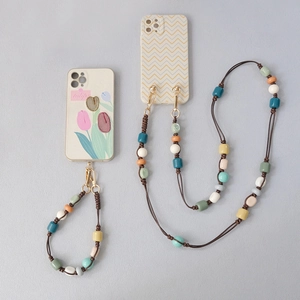 Detail view of tulip and wave patterned phone cases with colorful acrylic beaded straps
